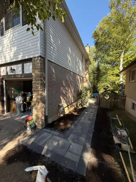 Paver walkway running along the side of the home