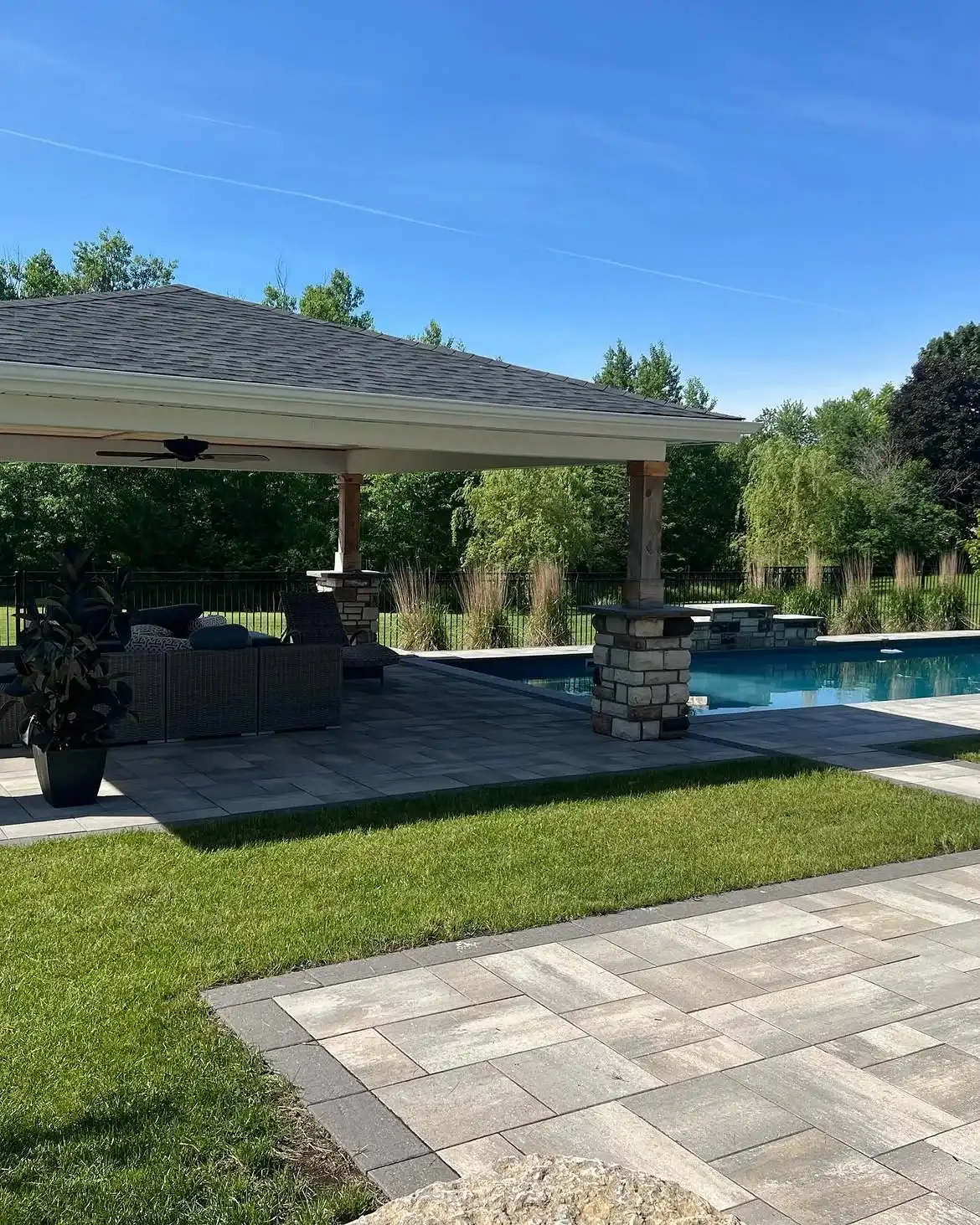 Covered pavilion beside a rectangular pool