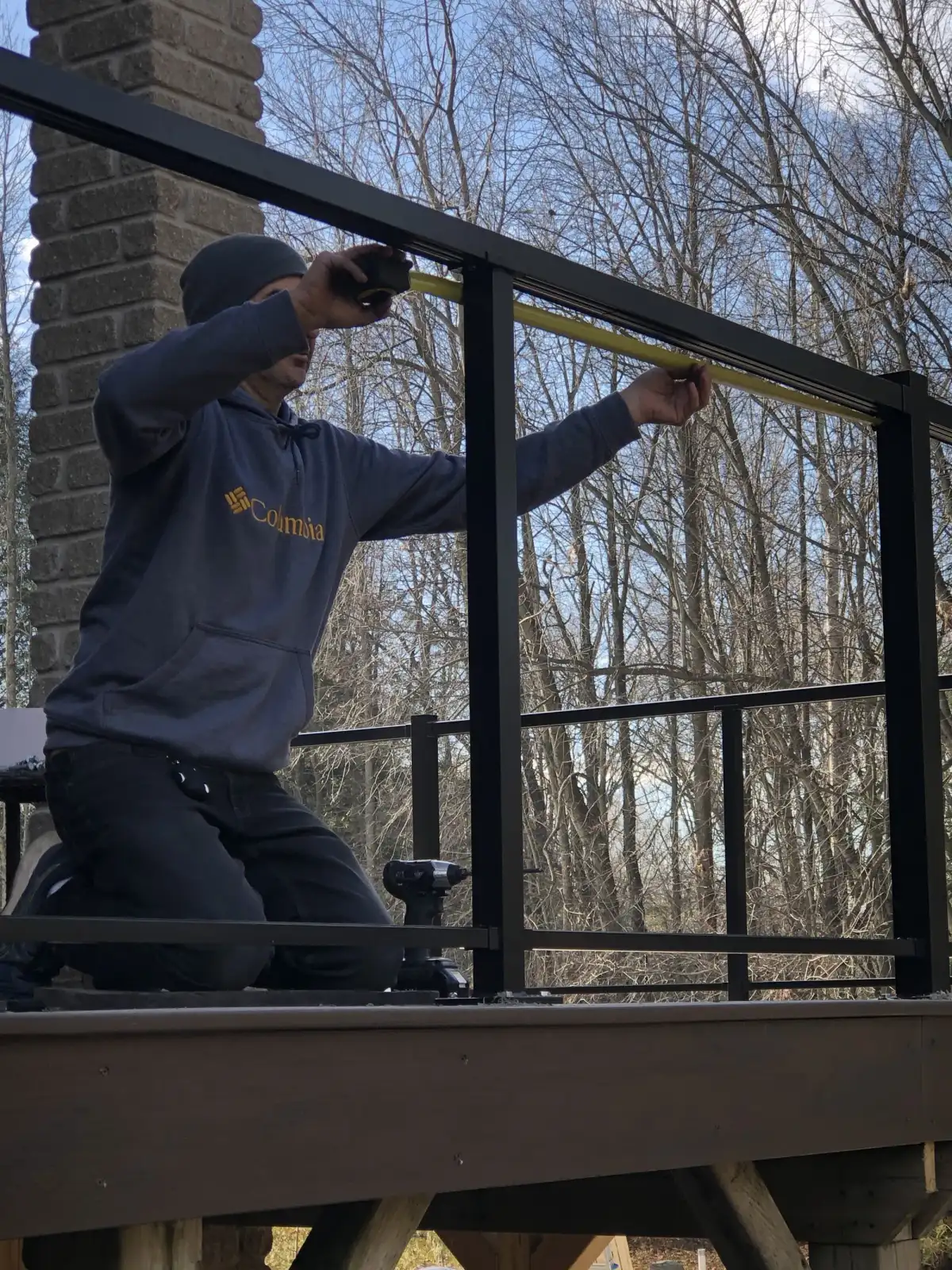An MWG crew member fitting a railing on site