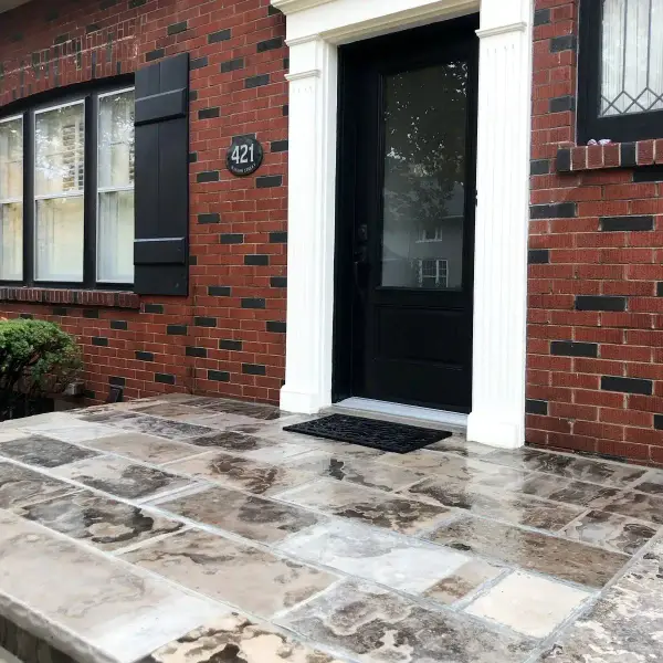 Large-format tiled front porch on a brick home