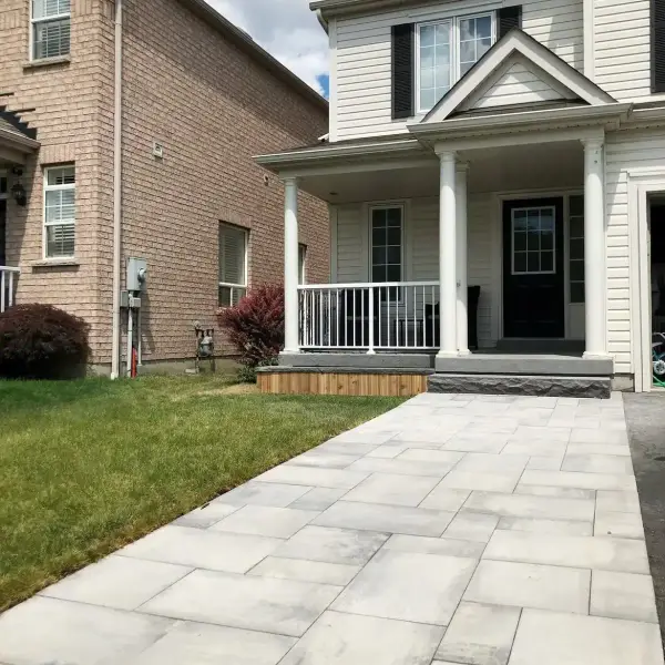 Paver walkway to a covered front porch
