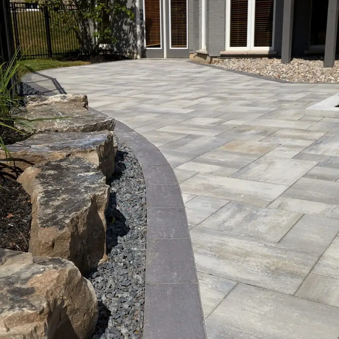 Paver patio with a natural-stone retaining edge
