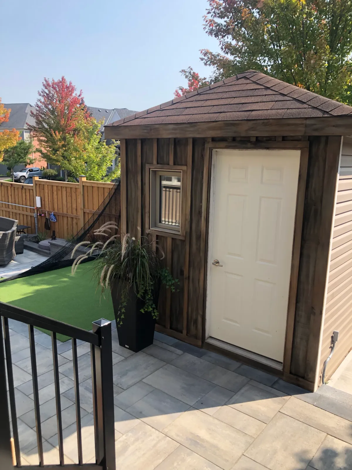 Cedar barrel sauna beside the turf lawn