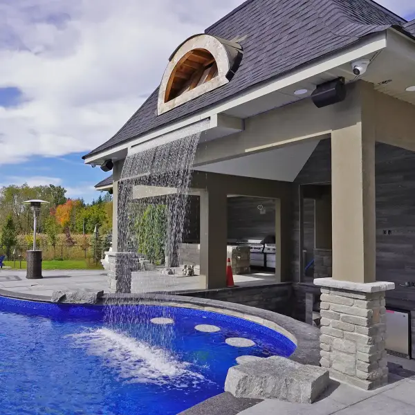 Pavilion with a sheer-descent waterfall over the pool