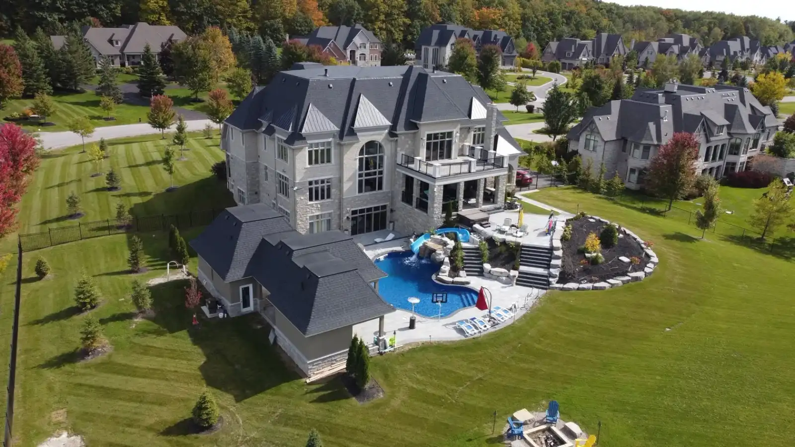 Aerial view of a backyard resort with a pool and water slide
