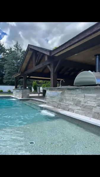 Pavilion and pool with a covered outdoor grill