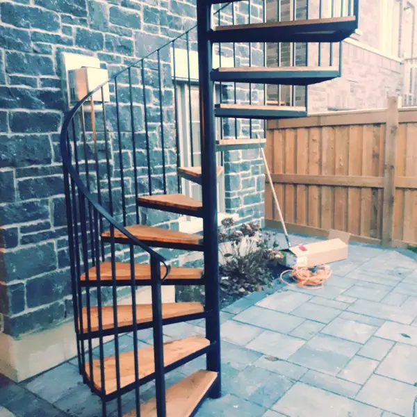 Custom black spiral staircase from the upper deck to the patio