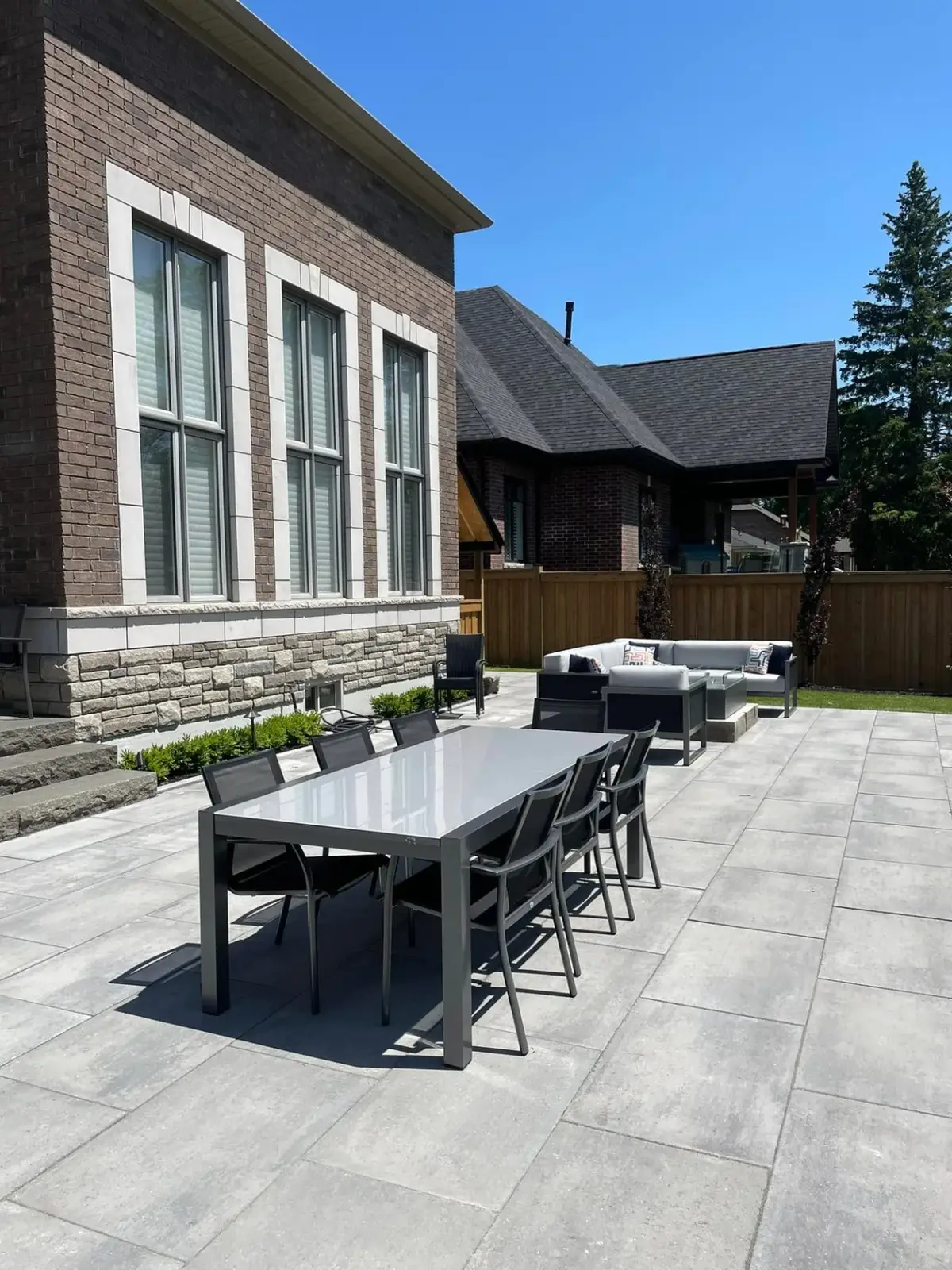 Modern lounge and dining furniture on a paver patio