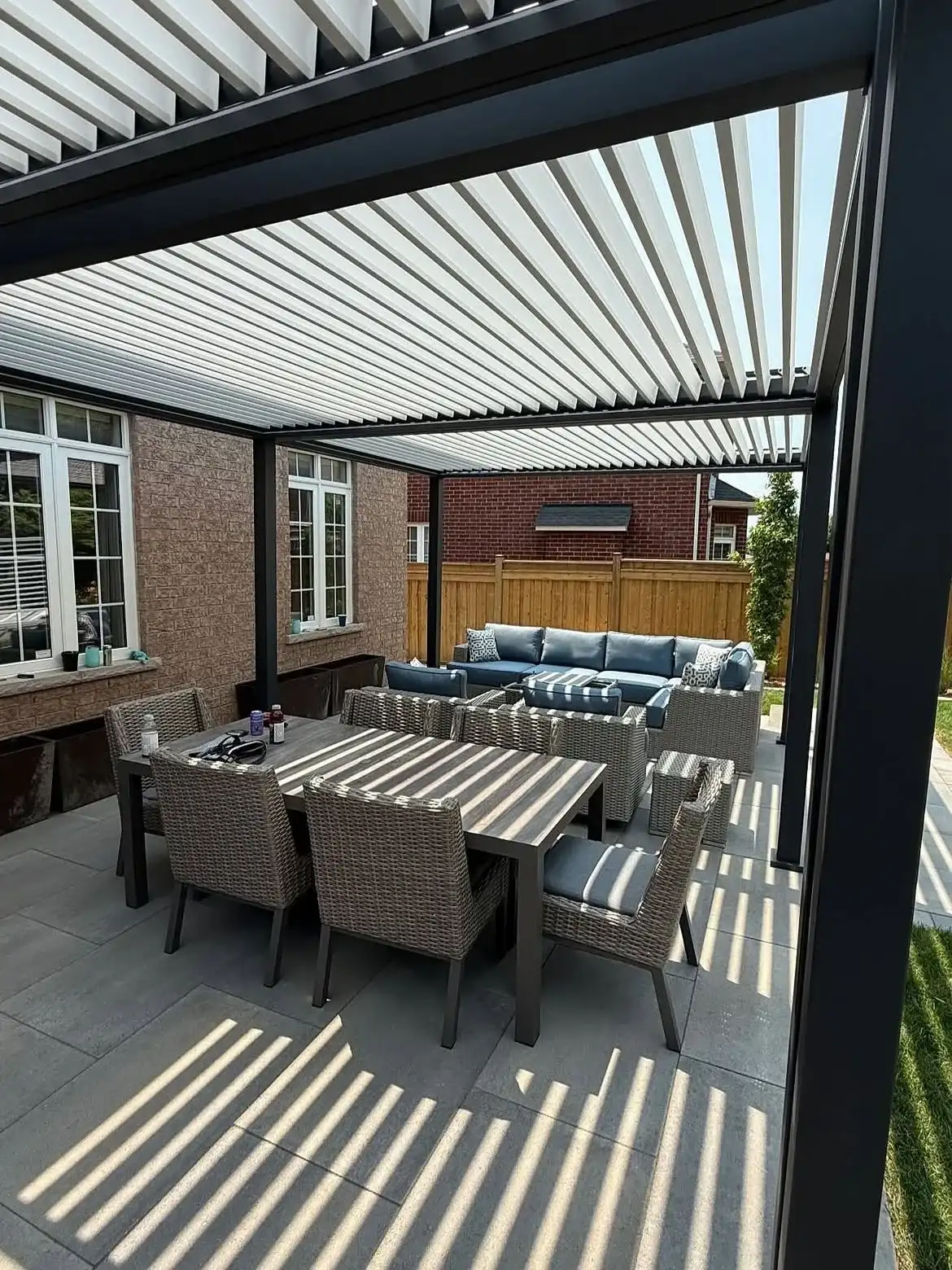 Louvered pergola over an outdoor dining set