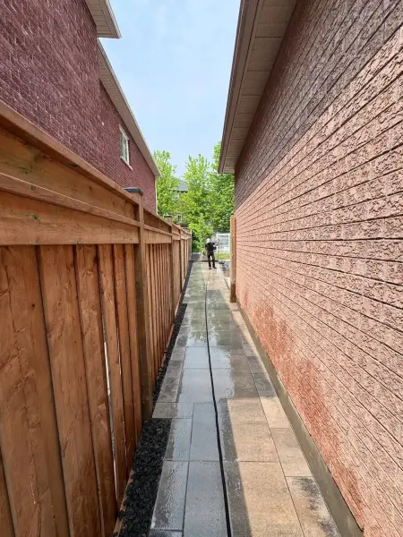 Paver walkway running along the side of the home