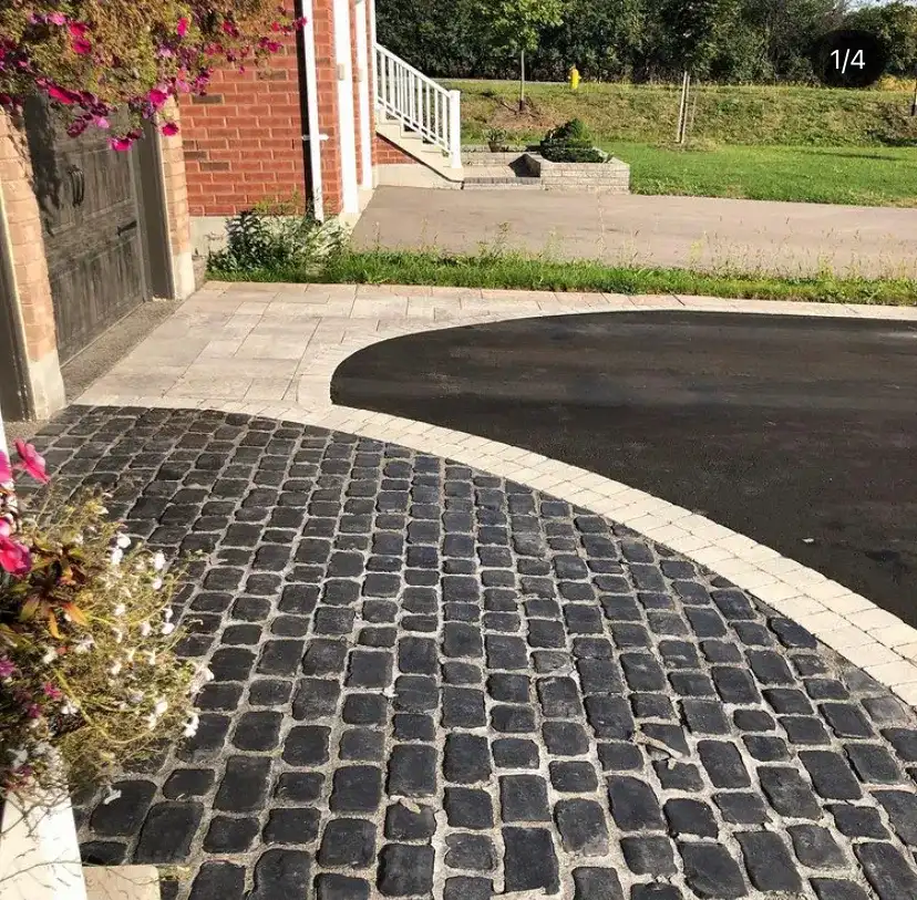 Cobblestone circular driveway with a paver border