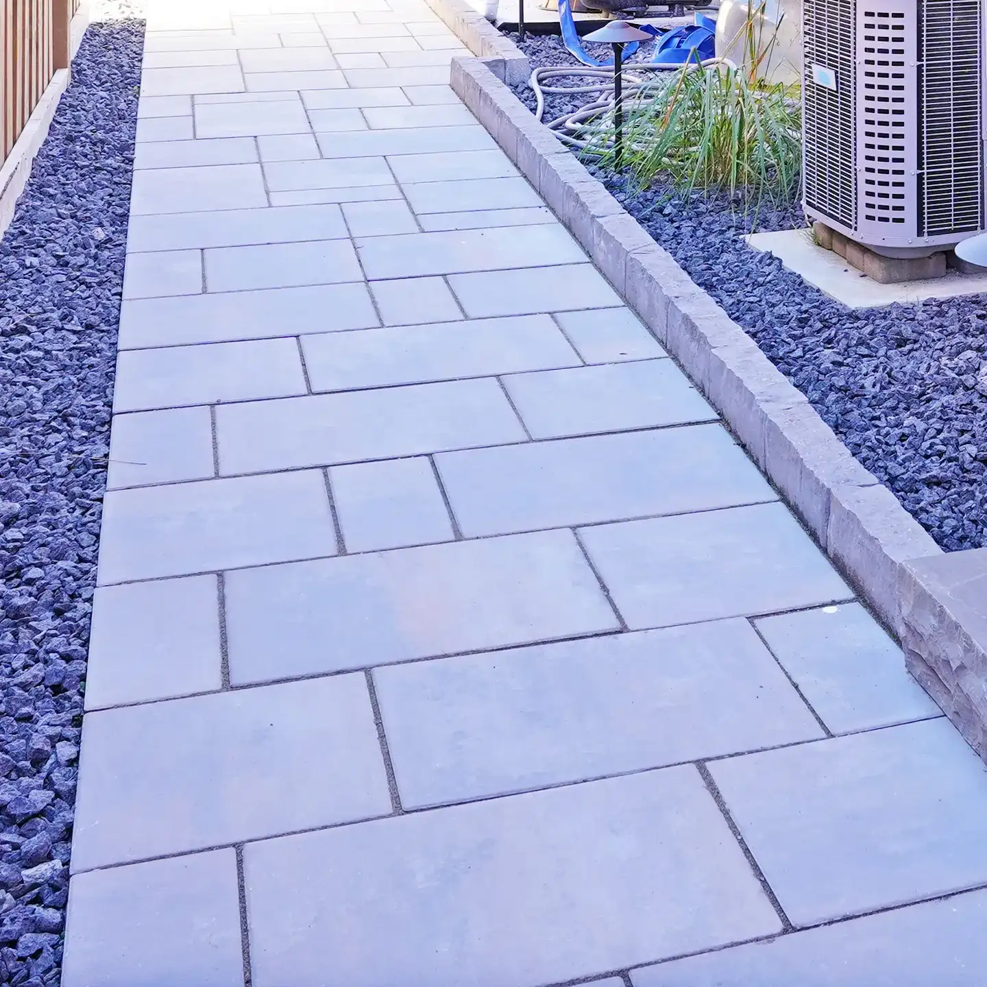 Wide paver walkway beside the drive