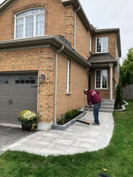 Paver walkway and steps to a brick front entrance