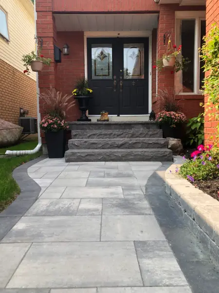Wide natural-stone steps to a double front door