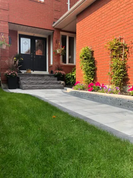 Curved paver walkway across the front lawn