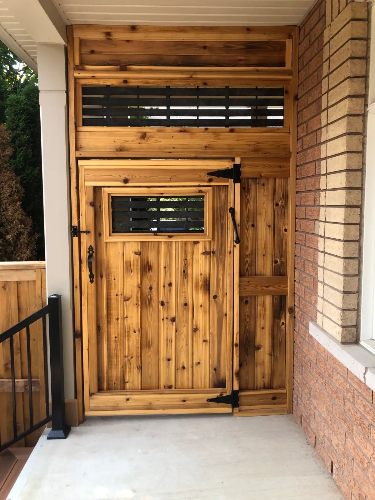 Custom cedar gate with a wrought-iron latch