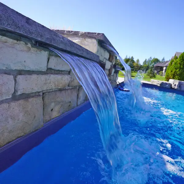 Stone waterfall spilling into the grotto pool