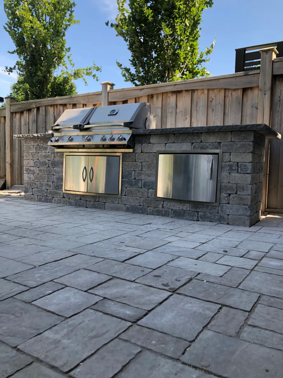 Stone-clad outdoor kitchen with a built-in grill