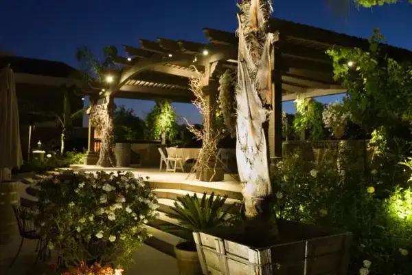 Pergola with a lit sculpture and planting